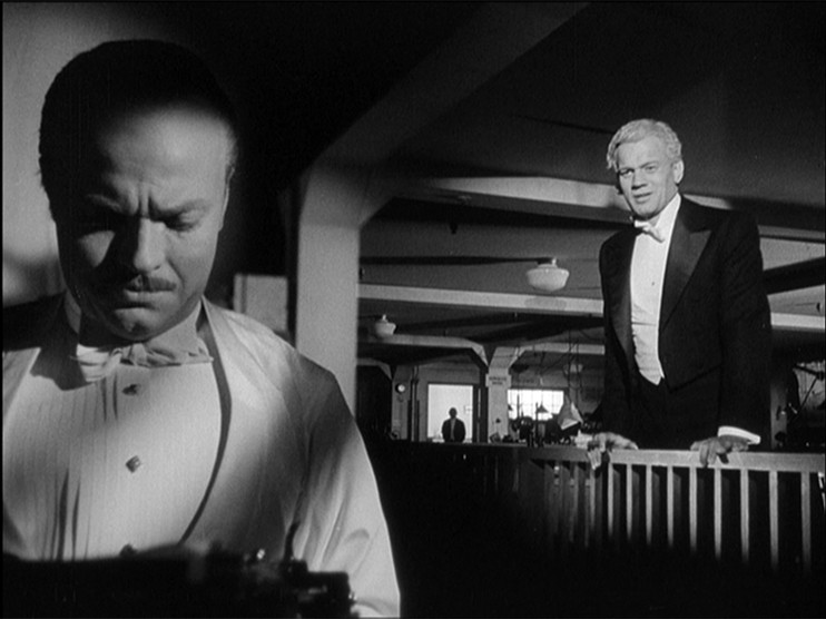 The newspaper reel at the beginning is asking the question of who Charles Foster Kane is. His true identity remains shrouded in the shadows.