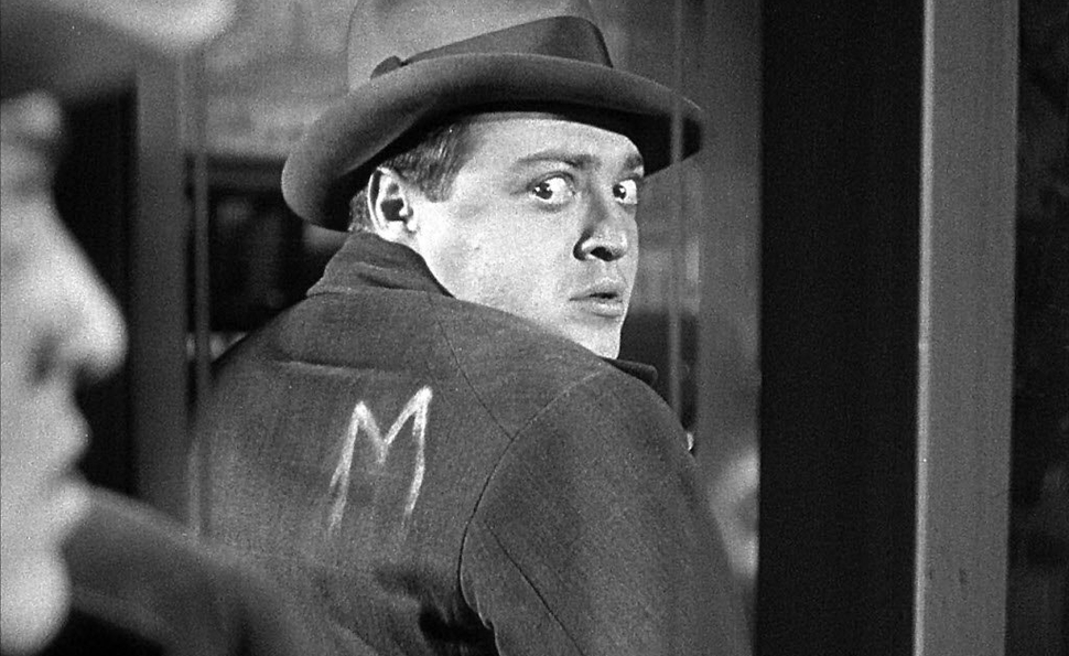 M stands for Mörder, i.e. Murderer.